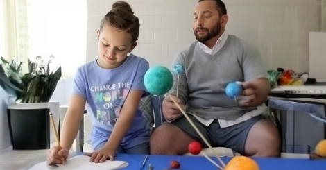 Father and daughter working on a science project