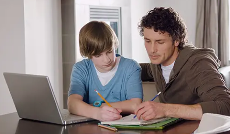 Father and son doing homework together