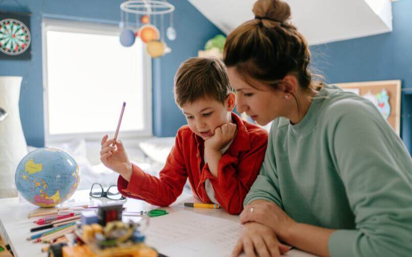 Mother assisting child with homework.