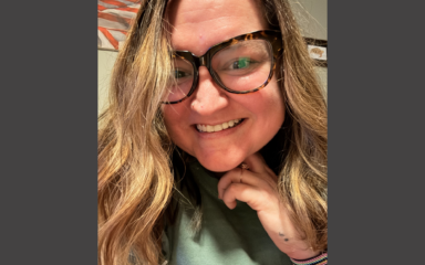 Woman wearing glasses and smiling